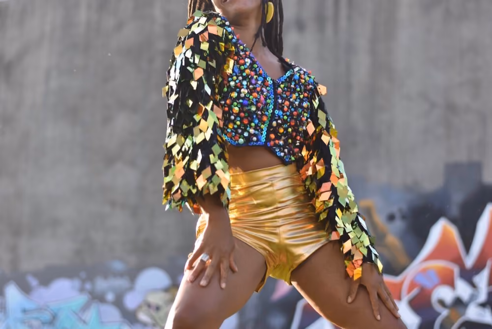 Miss Renee Simone in metallic gold shorts and a sequin top